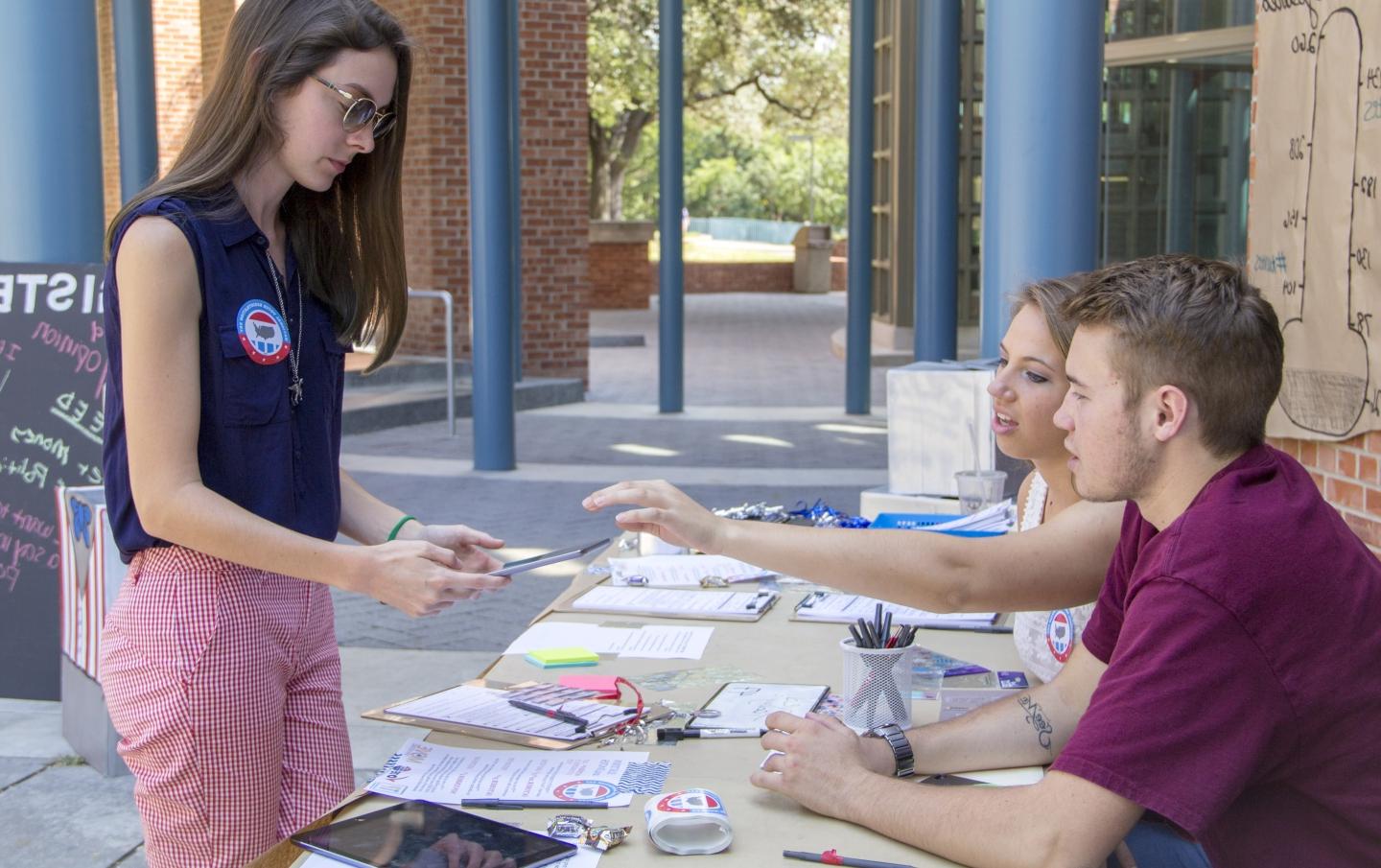 Photo of students talking at a table at a Voter Registration event